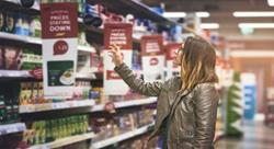 Shot of a young woman shopping at a grocery store