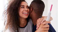 Couple Celebrating Positive Home Pregnancy Test Result