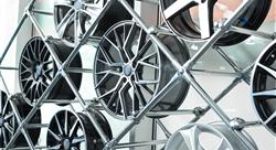 Different automotive wheels on stand in auto shop