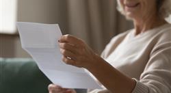 elderly woman reading bill or medical statement