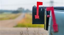 three closed mailboxes at the side of the road