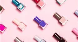 close-up of nail polish bottles patterned on a pink background