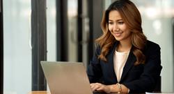 asian woman in using laptop in her office