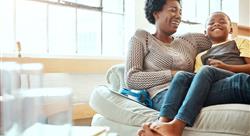 mother and son sitting and laughing together on the couch