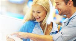 male and female smiling together as they look at a piece of paper