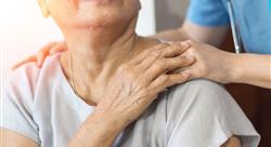 healthcare worker in blue scrubs placing hand gently on senior woman's shoulder