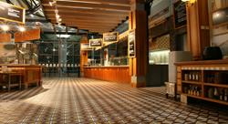 lobby of a large, empty restaurant with a variety of serving stations along with neatly stacked serviceware