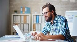 casual man typing on laptop