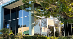 Front entrance to TO Printing facility with trees and shrubs